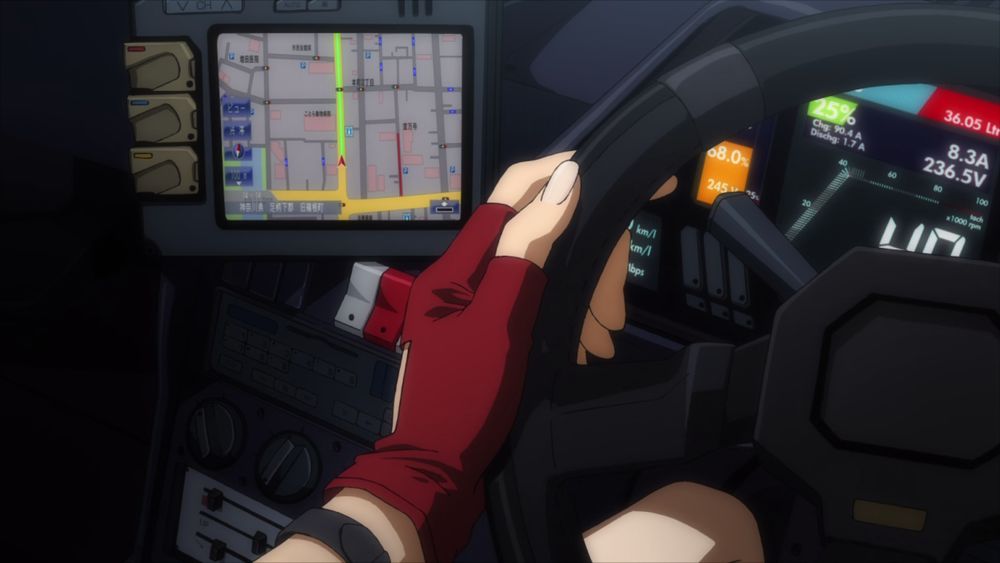 Misato's hand on the steering wheel of her car while her GPS is on