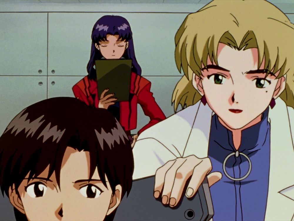 Misato reading from a clipboard while Ritsuko looks over Maya's shoulder