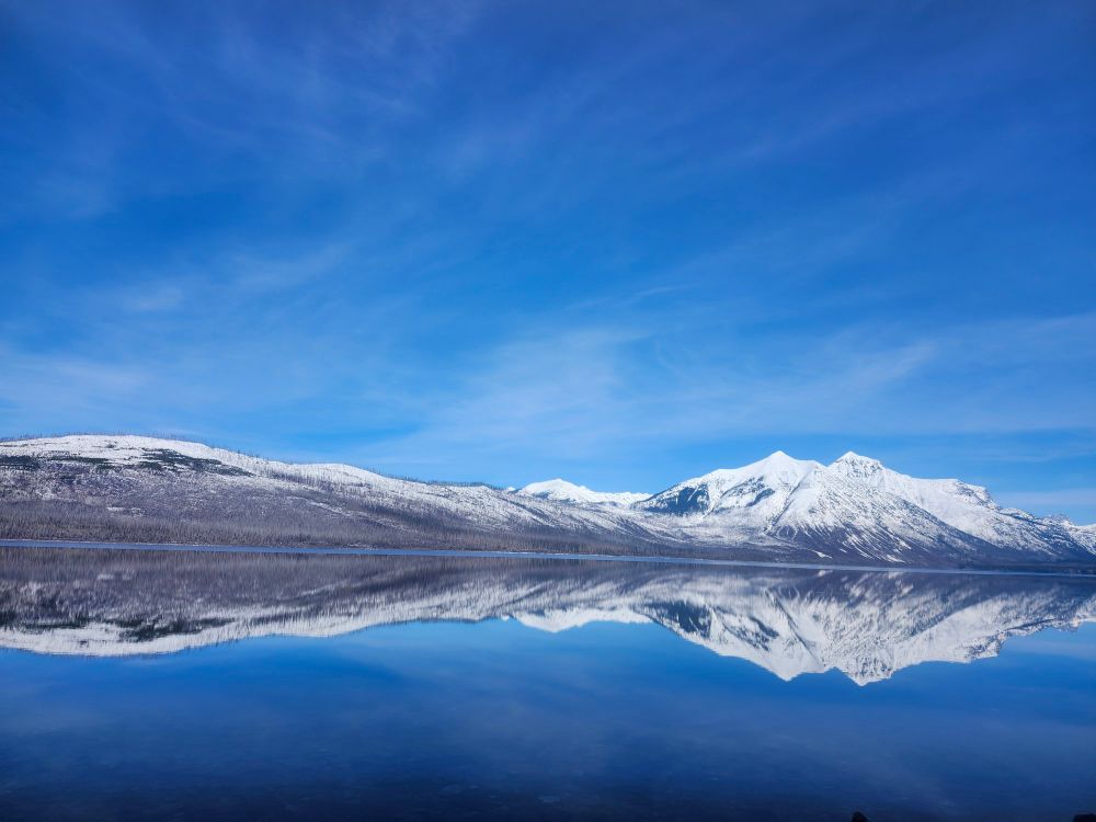 Mountains and their reflection off of Lake Mcdonald in Glacier NP.