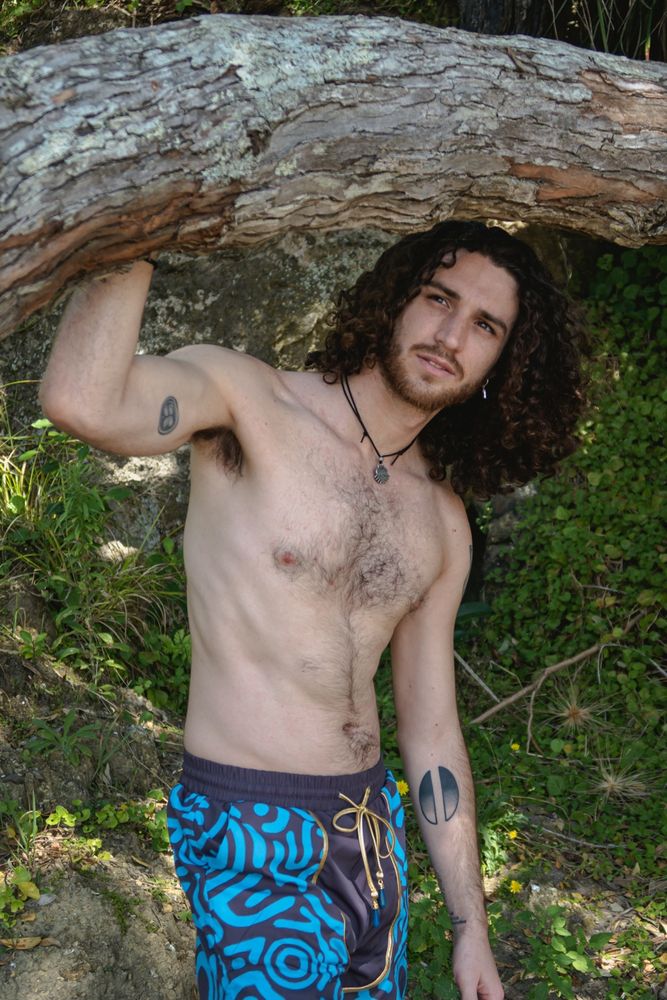 Curly-haired muppet guy in shorts