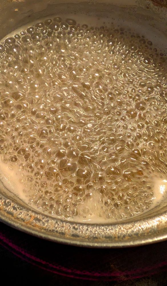 A pot of boiling liquid, a slight amber color