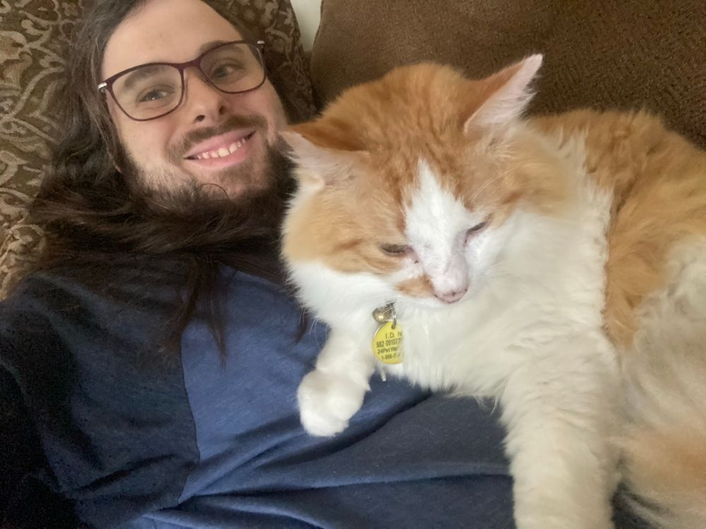 Bixby sprawled out and sitting on my chest while we watch a movie at home.