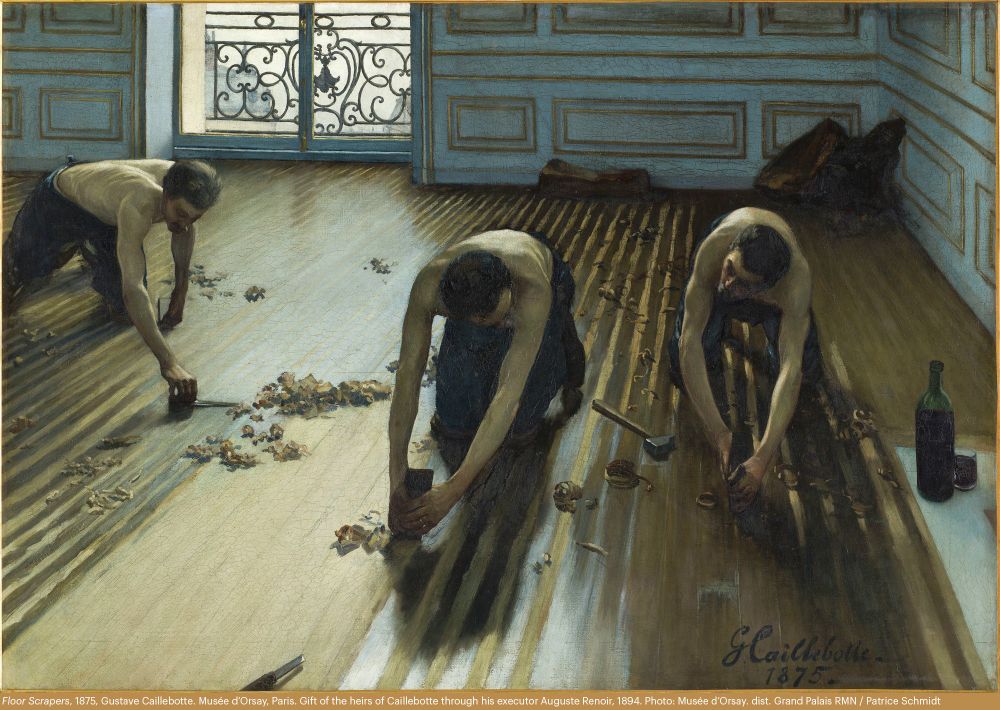Three shirtless men bend over as they knee on the floor of a room in a wealthy Parisian estate, each a tool in their hand meant to scrape the floor clean. Detritus from their work is strewn across the floor and an open bottle of wine can be seen in the corner of the painting.