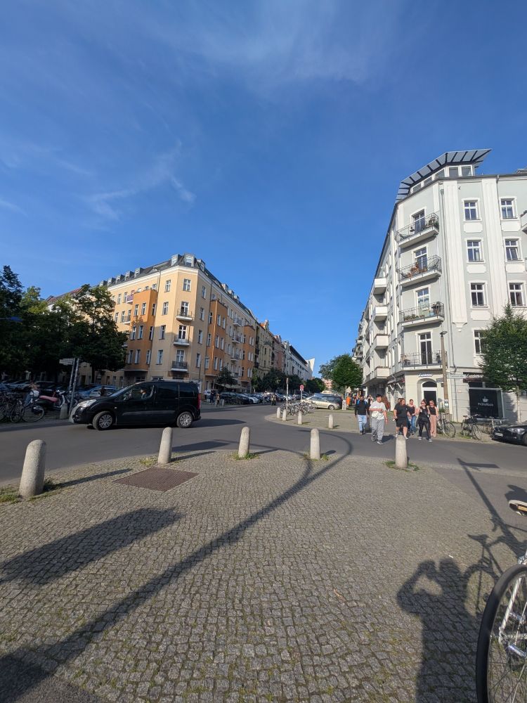 Intersection in Berlin with cobbled walkway.