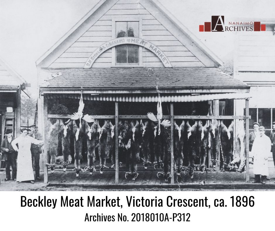 Photograph of Beckley's Meat Market in Nanaimo BC showing deer carcasses hanging in front of store.