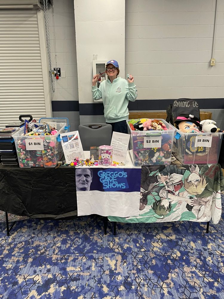 Janessa standing behind our vendor table 