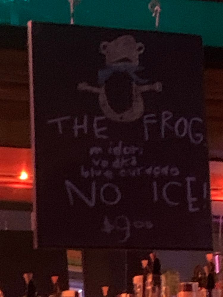 A small chalkboard advertising the cocktail special at Mad Hanna in Portland, Oregon. “The Frog” is made with Midori, Vodka, and Blue Curaçao. NO ICE.