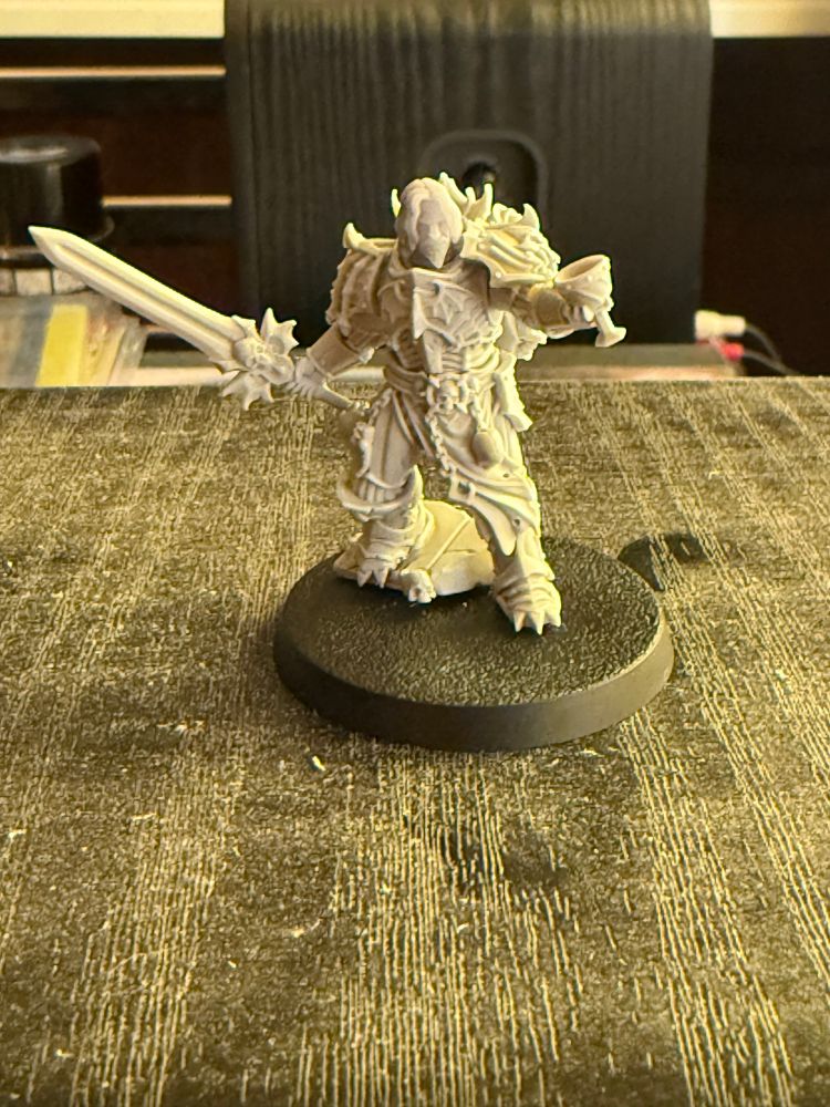 ((Unpainted resin mini of a Night Lord Chaos Lord, bearing a sword and a chalice.)