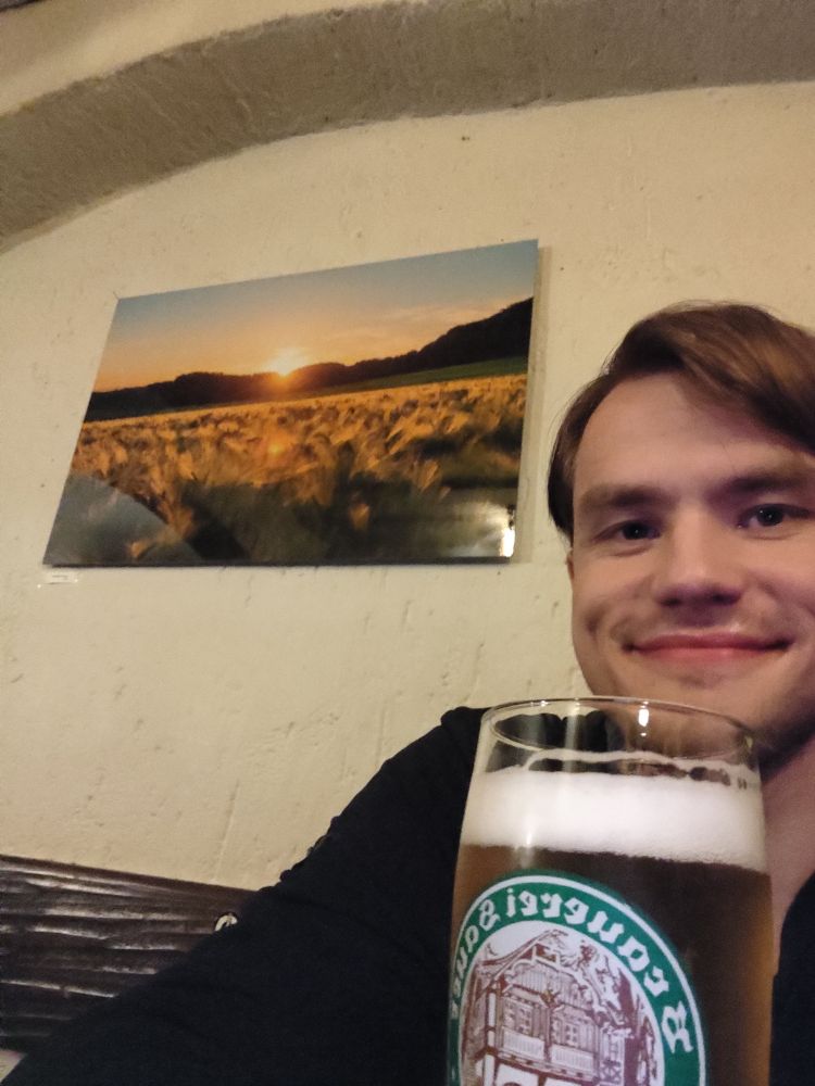 Me sitting in front of one of my photography prints in my exhibition in a local bar.