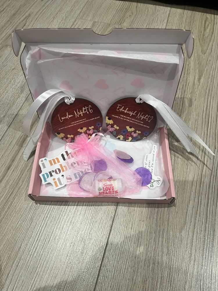 Gift box with circle purple and pink confetti, two Taylor Swift lyrics and two circle 
wooden decorations with personalised dates and surprise songs for London N6 and Edinburgh N2 of the Eras Tour