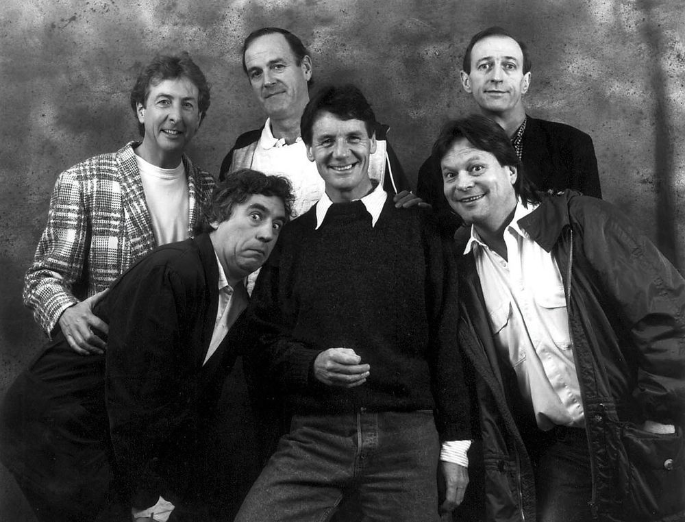 An undated b/w photo of the six members of Monty Python. Terry Gilliam is at bottom-right, wearing a white shirt.
Source: NZ Herald