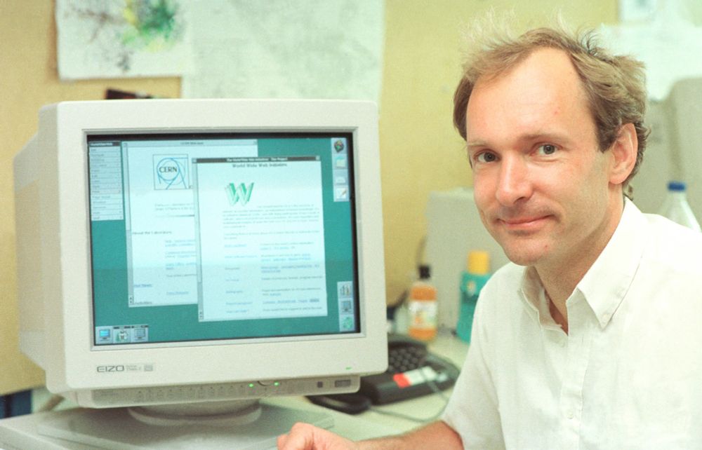 A color photograph of Tim Berners-Lee sitting at a computer work station.
Image source: Scientific American 