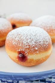 A photo of a jelly-filled doughnut, with powdered sugar on top = berliner.