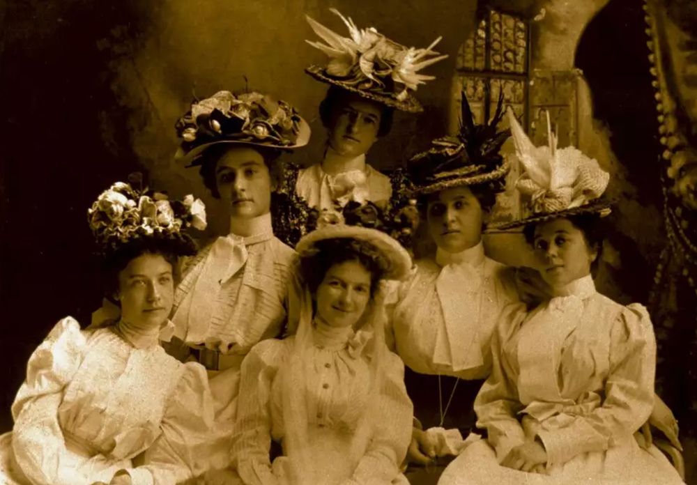 A sepia-toned photo of Mary Ritter (left) and five other students of DePauw University in the 1890s. 
The hats they're wearing deserve an effusive write up of their own. It's impossible to do them justice here. They are festooned with flowers, enough to fill a small greenhouse. 
Image source: DePauw University Archives and Special Collections