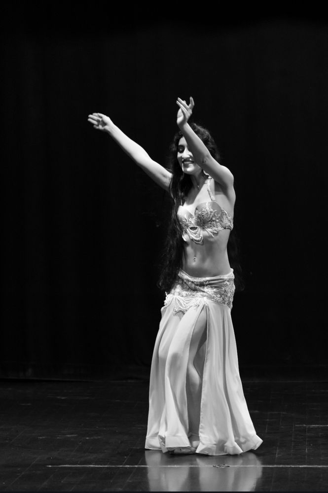 Me smiling while dancing with my arms half up