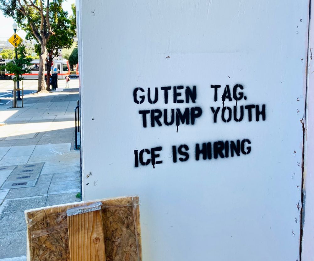 Stenciled graffiti that reads, “Guten Tag, Trump youth ICE is hiring”
