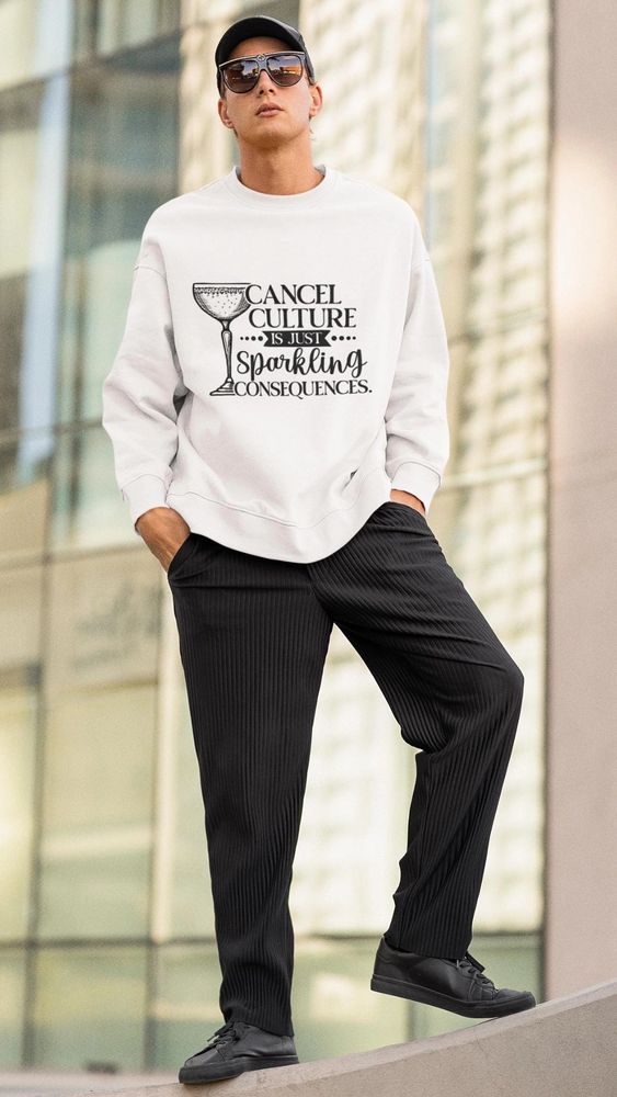 A guy wearing a white sweatshirt that says "Cancel culture is just sparkling consequences"