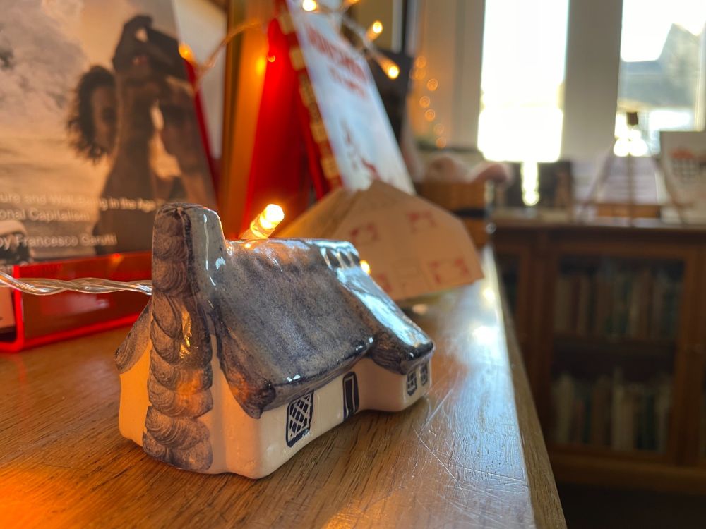 A photo of a tiny house clay figurine - part of Hugge library display 