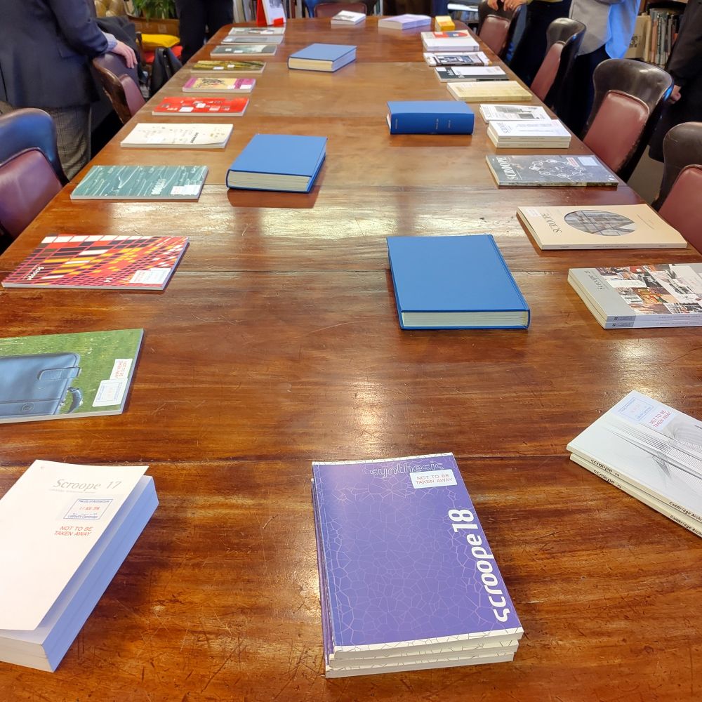 A colour photo of the long table in the Architecture room of the AHA Library, with all issues of Scroope journals placed on the table.