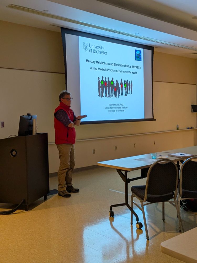 Person presenting to a group in a lecture hall
