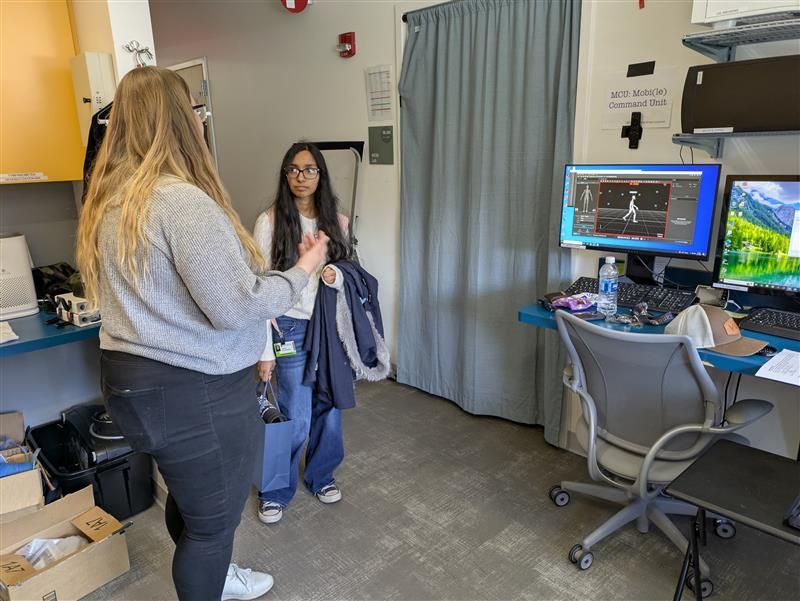 bench mentor showing student part of lab