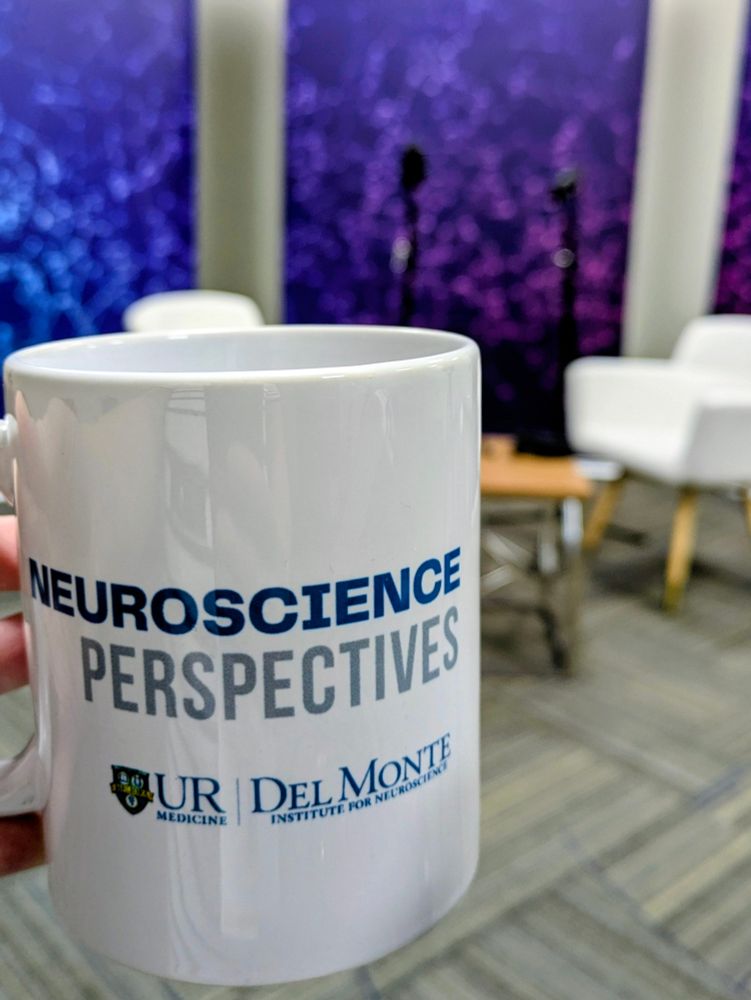 Neuroscience Perspectives mug with podcast set in the background 