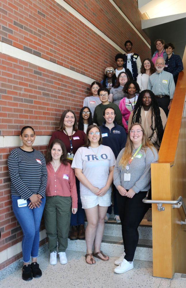 students, bench mentors, and PI's standing together on stairwell