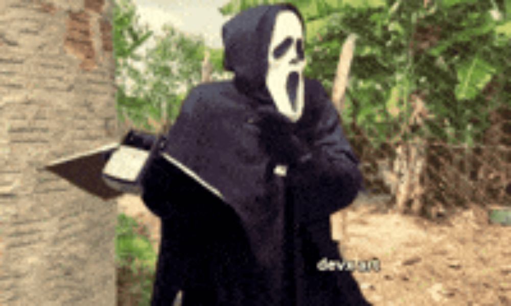 a person wearing a scream mask is standing in a field with trees in the background