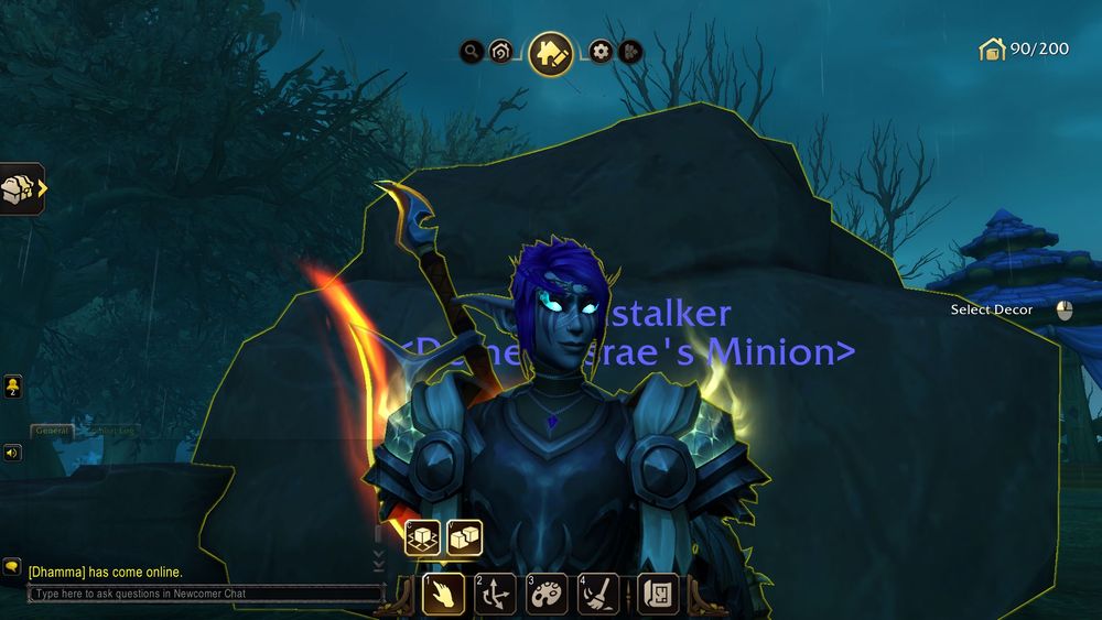 My Death Knight (night elf) in WoW with a giant flames sword and short purple hair in front of a very large boulder on her newly acquired cemetery plot