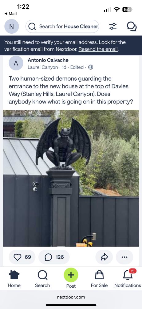 A screenshot of a post from NextDoor containing a photo of a large demon statue,  perched on a fence outside of a house in Los Angeles.  The original poster seems quite nervous.  