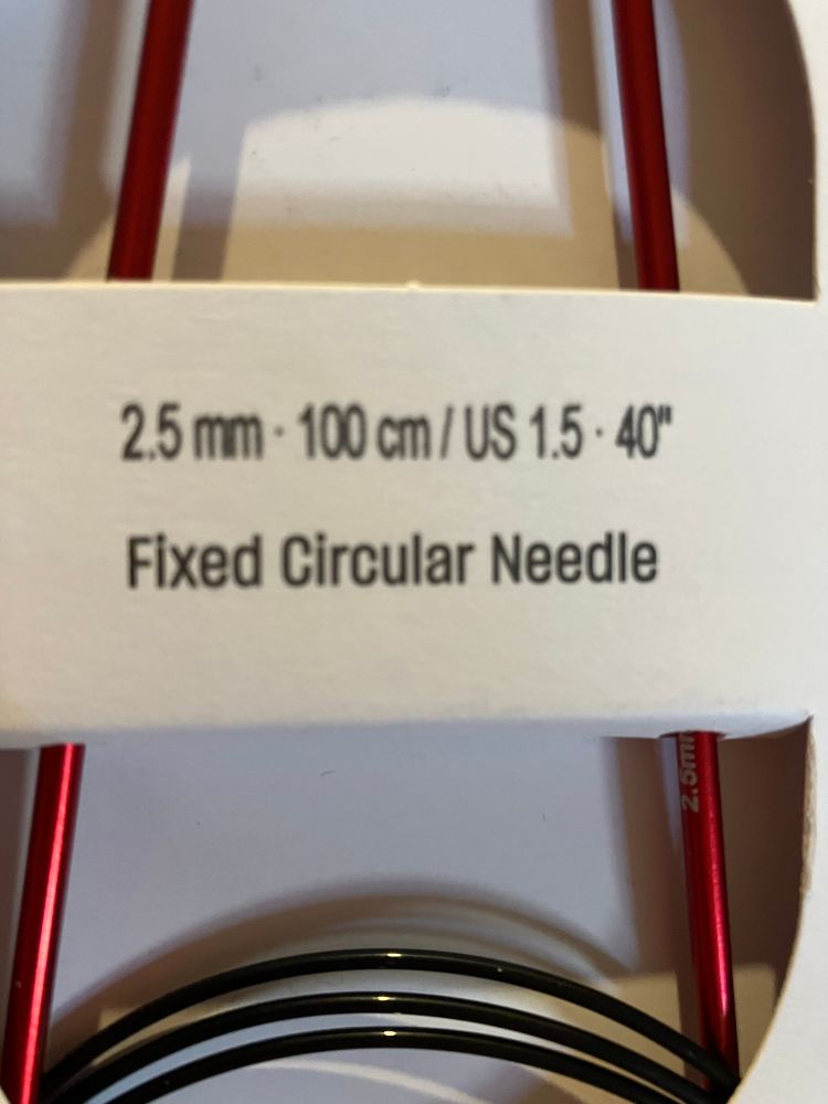 Close up of the label on a set of circular knitting needles. Label reads: 

2.5 mm - 100 cm / US 1.5 • 40"
Fixed Circular Needle