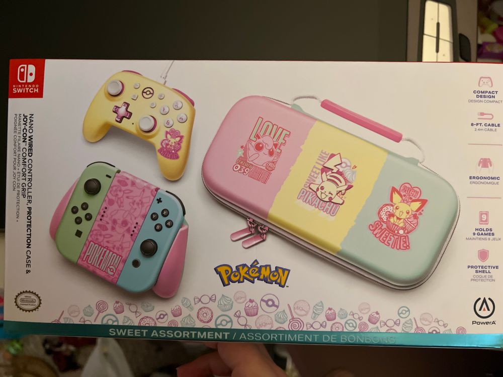 a box containing a pokemon themed controller , joycon grip, and carrying case