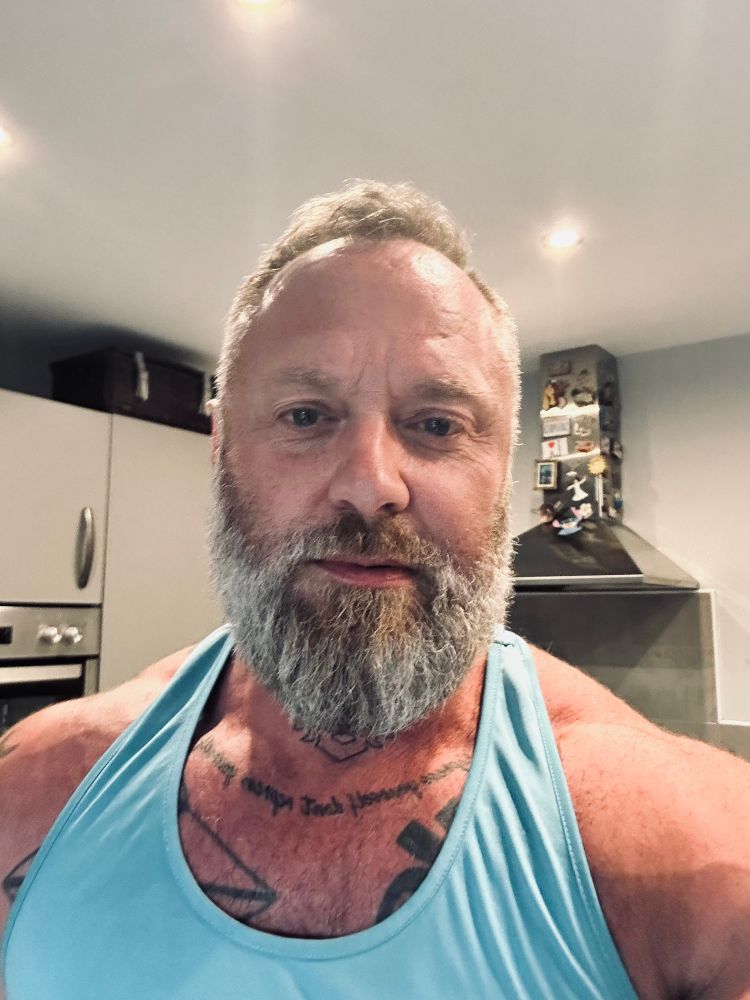 Weird kitchen selfie in turquoise vest 