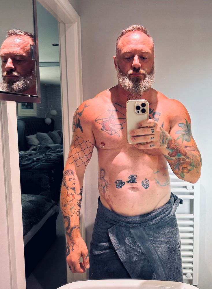 Selfie in en-suite with towel wrapped at waist 
