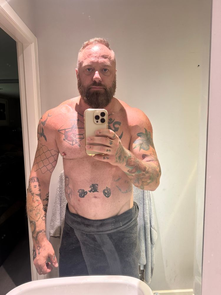 Selfie wrapped in dark grey towel in en-suite 