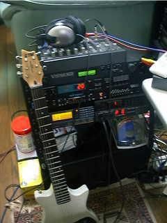 a crusty pic from the late 90s showcasing a lot of music gear. from top to bottom:
from the top :
audio-technica ATH-A10 (headphones)
Mackie MS1202 (mixer)
E-mu Vintage Keys
Roland M-BD1
MOTU MIDI Express XT
left: Roland SC-88Pro
right above : YAMAHA R-100
right below : Roland GI-10

and a Roland GC-10 (midi guitar) leaning on the stack