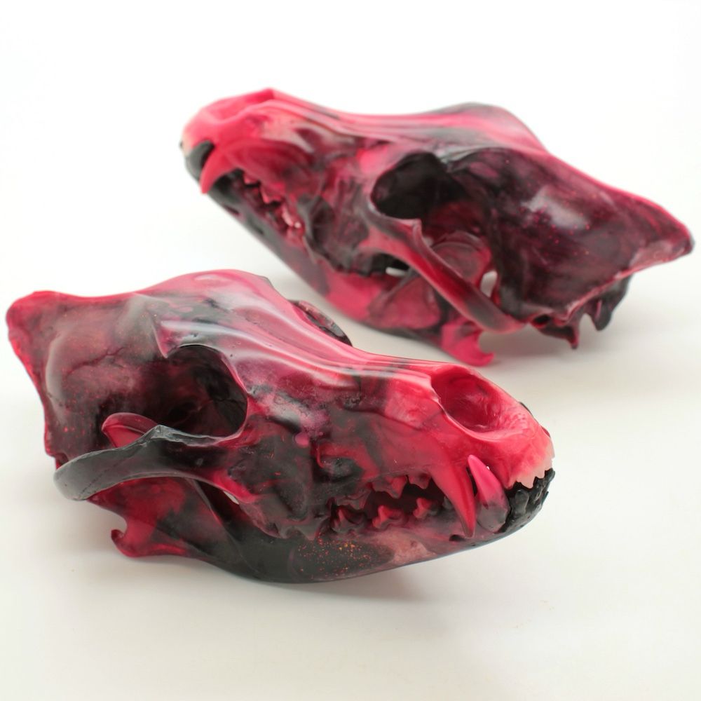 Resin wolf skulls in red and black swirling colors.