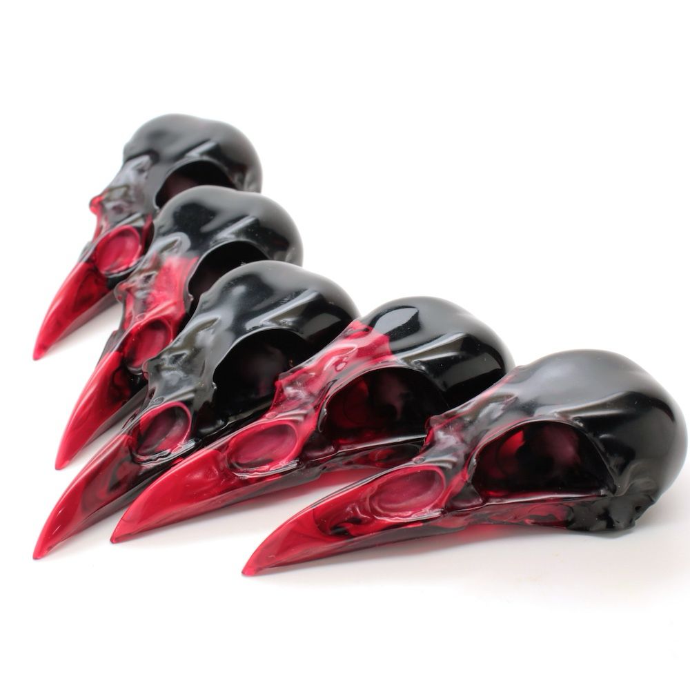 Resin magpie skulls, red swirling into black.
