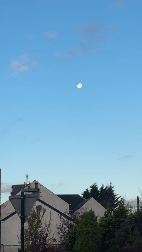 moon in the sky against bright blue sky of morning 