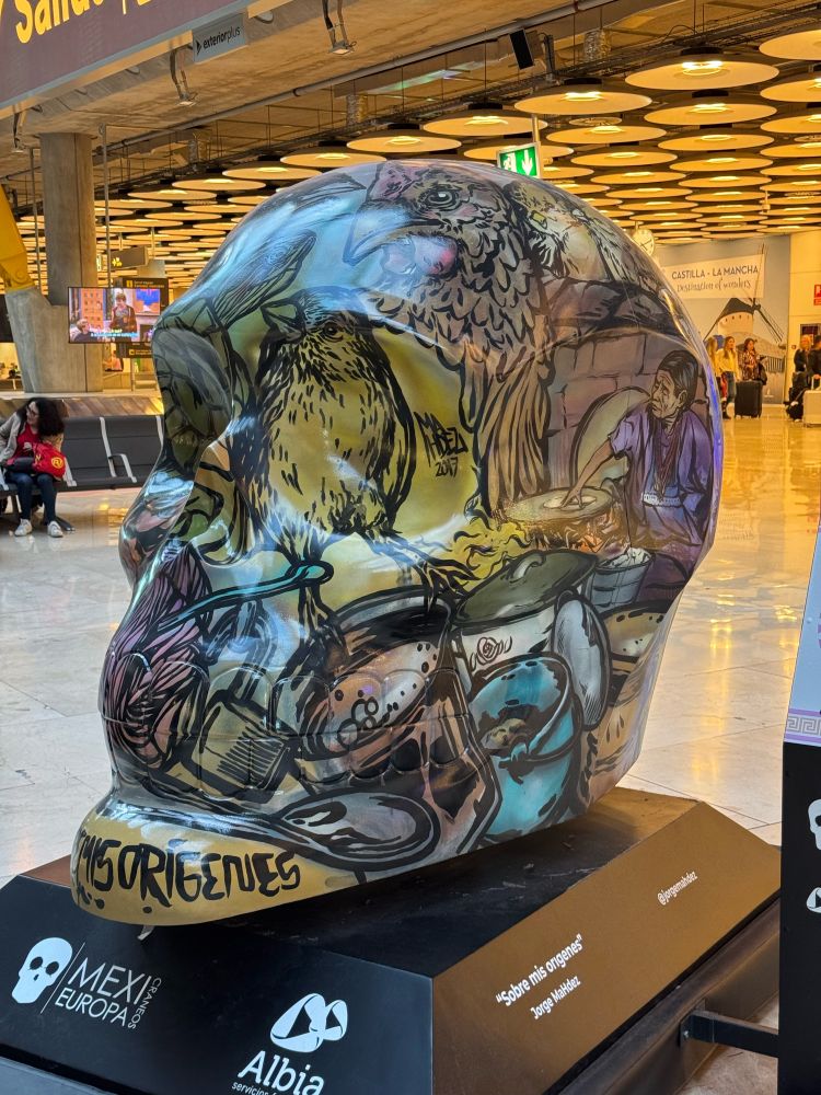 A large “sugar skull” sculpture in many colors