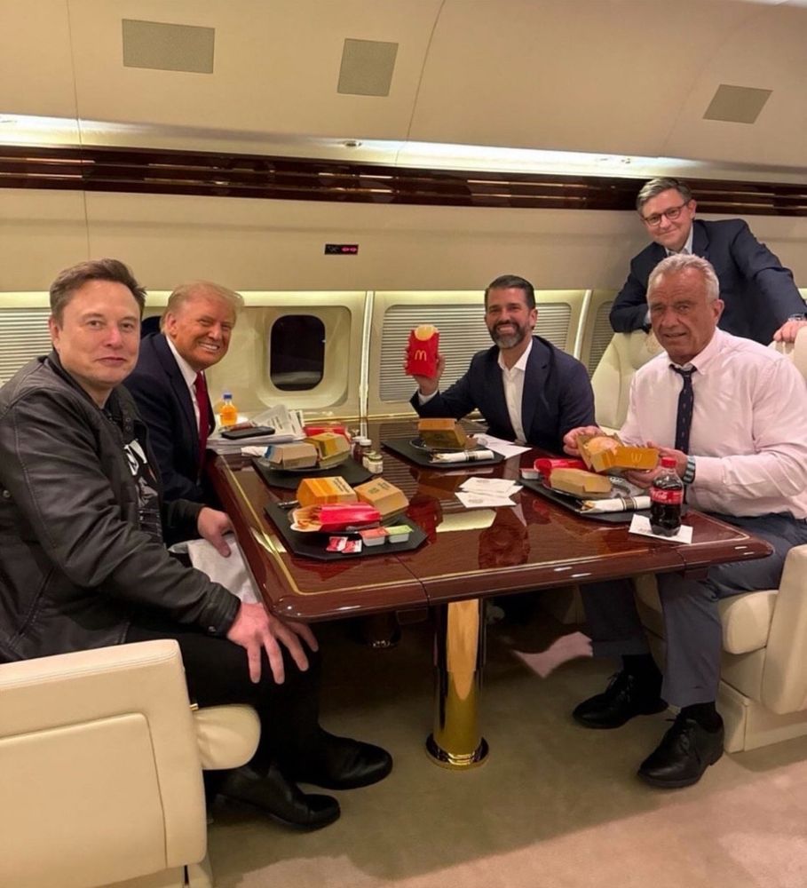 Trump, RFK, one of Trump’s idiot children, Mike Johnson and Elon Musk’s smug, punchable face all sitting on an airplane eating McDonalds. 