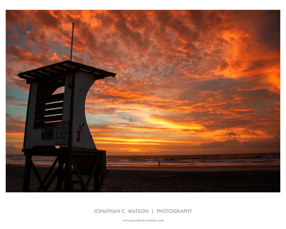 A lifeguard tower at Wrightsville Beach (NC) is silhouetted by the rising sun.