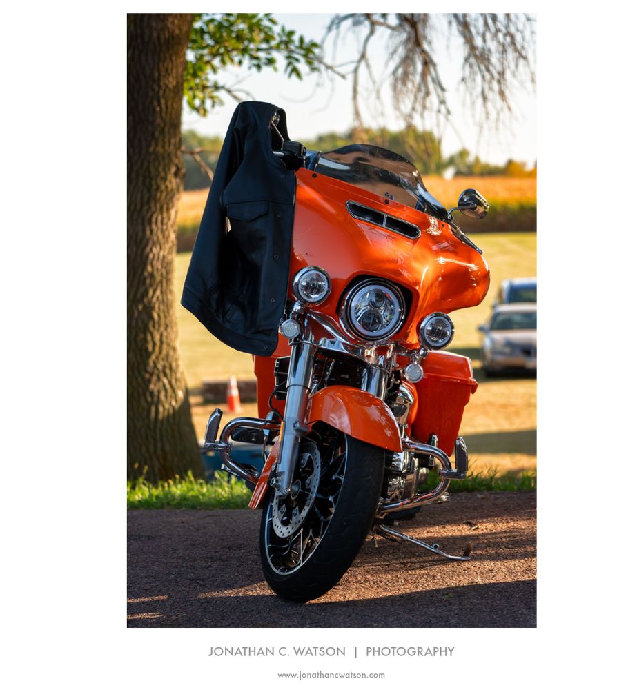 An orange motorcycle is parked outside of Pilot Mike's Roadhouse, near Sioux Falls, SD