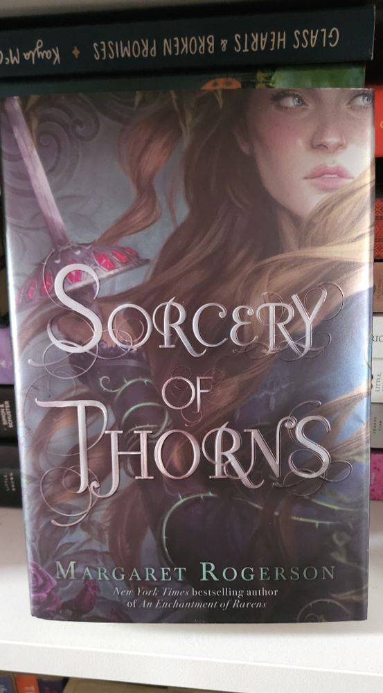 The cover of the book "Sorcery of Thorns" with a girl holding a sword