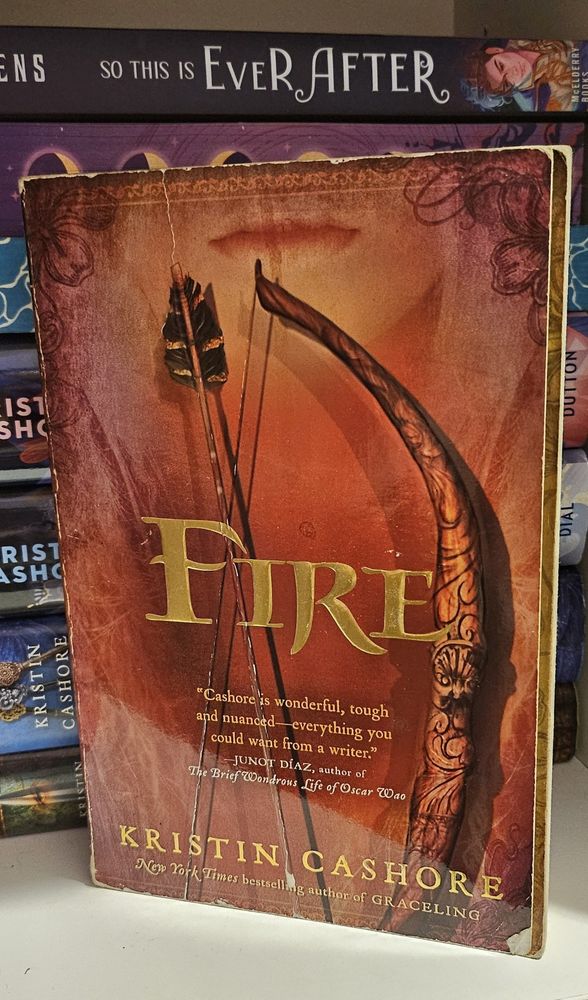 The book "fire" by Kristin cashore displayed on a bookshelf