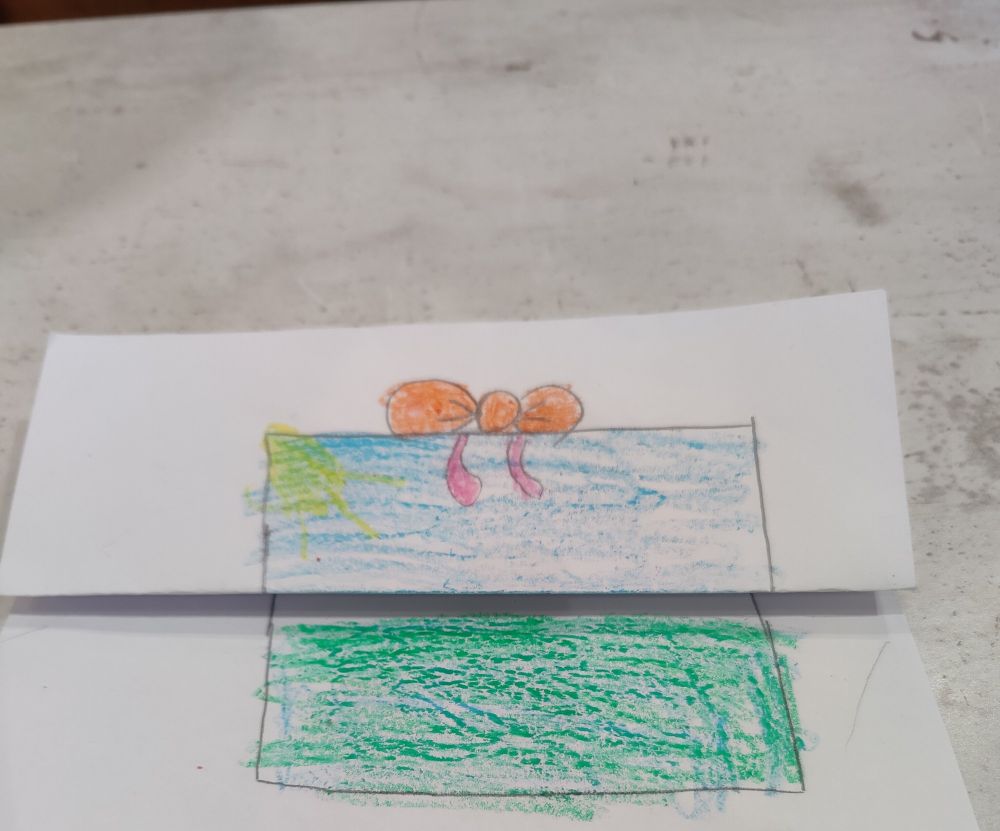 Folded paper with a hand drawing of a present. 