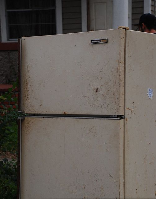 An old, rusted and abandoned fridge.