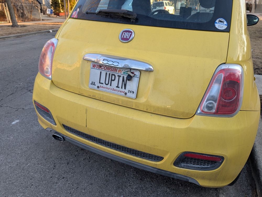 A yellow fiat. It's license plate reads LUPIN.