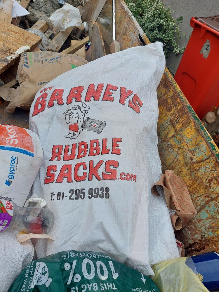 White rubble sack with red script that reads Barney's Rubble Sacks