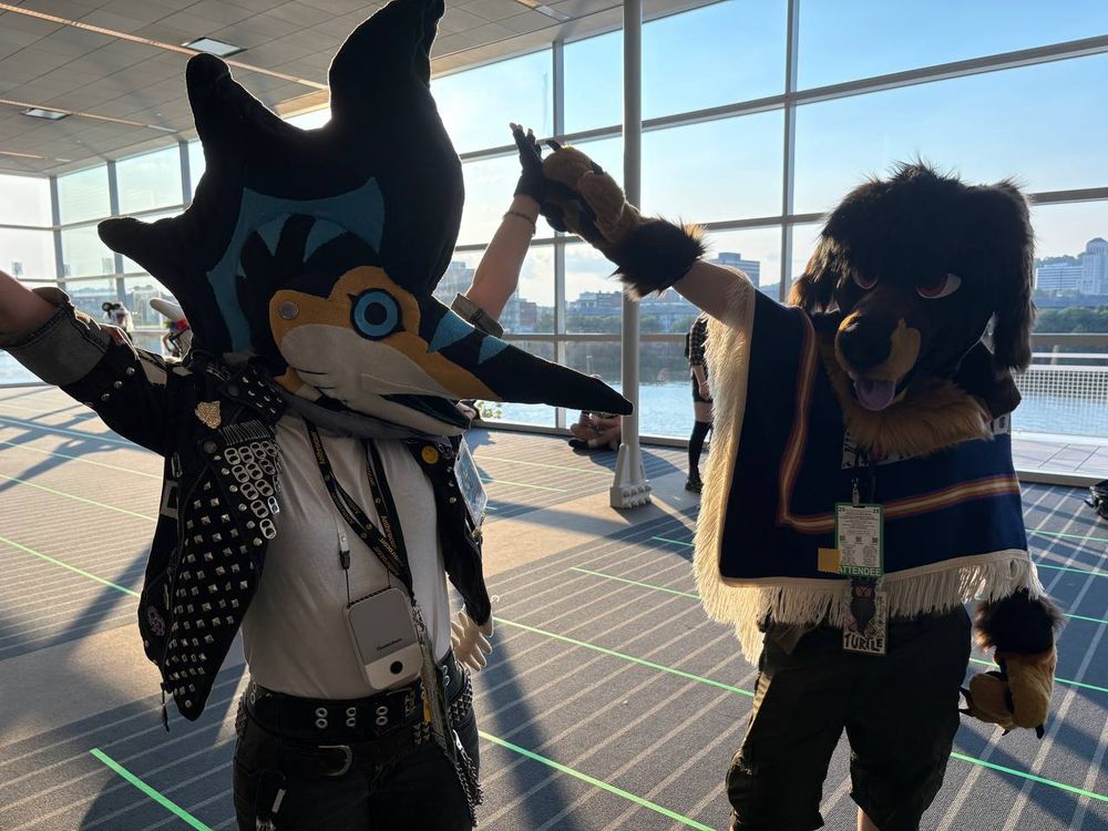 A photo taken inside the David L. Lawrence Convention Center of me in my marlin fursuit head; and my friend in her Dachshund fursuit